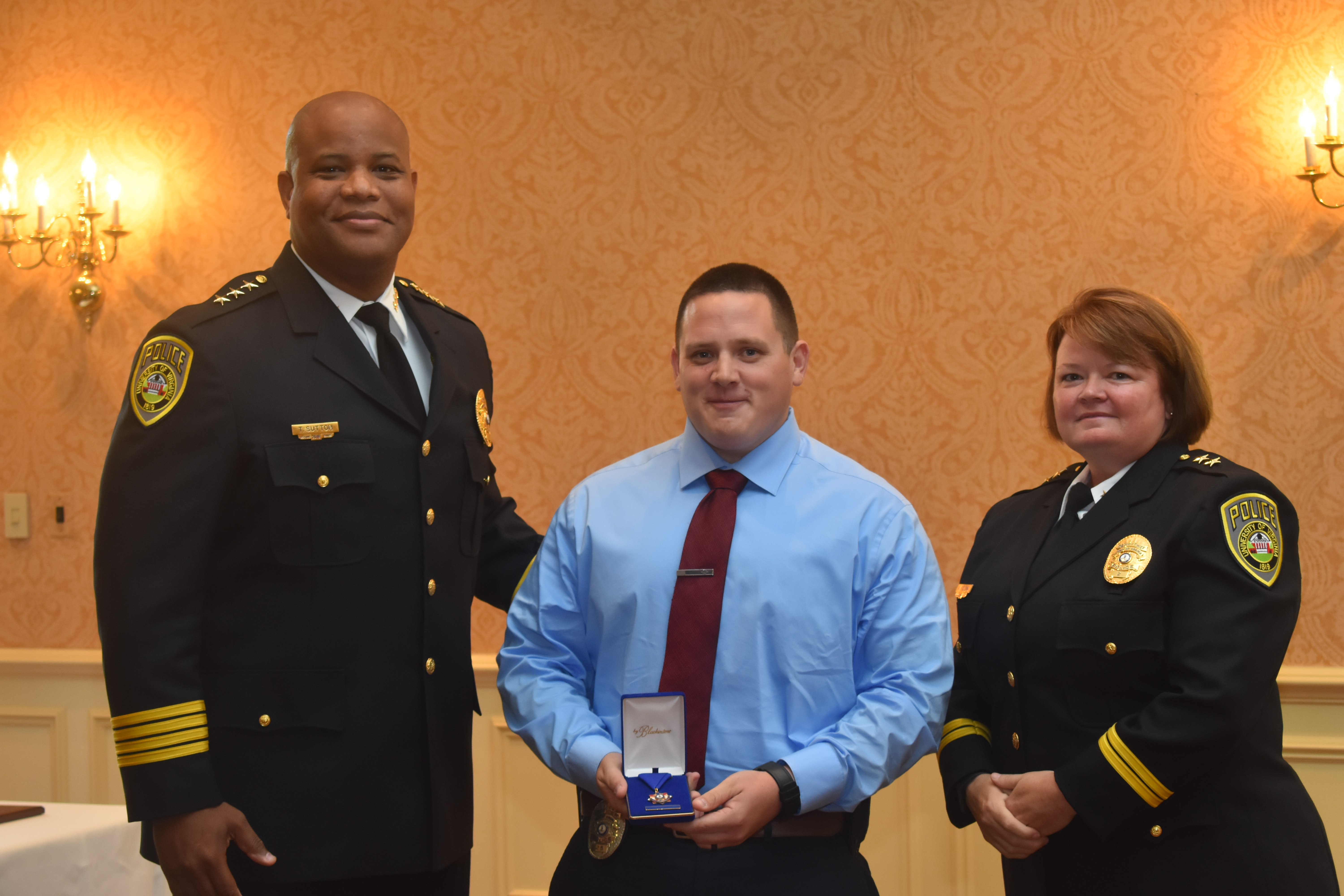 Dean Dotts shows his lifesaving medal flanked by Chief Sutton and Deputy Chief Fielding.