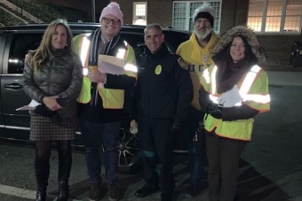 Members of UVA Safety and Security Committee wear reflective yellow vests and warm clothing for Night Tour.